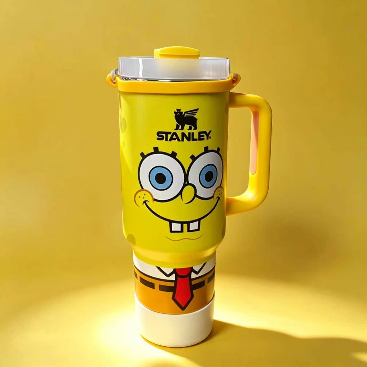 Stanley 40oz insulated tumbler featuring SpongeBob face design, bright yellow body with red tie details, yellow handle
