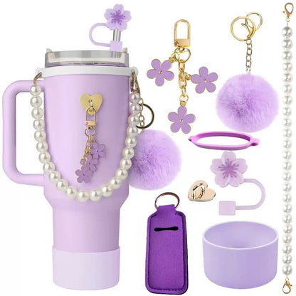 Aesthetic tumbler accessory bundle with pearl strap, fluffy pom-pom keychain, flower straw topper, silicone cup boot, and decorative charms for stylish drinkware customization.