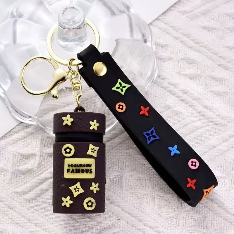 Black keychain with colorful designs on a textured surface