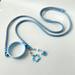 Blue pet leash with a star-shaped charm on a light gray background
