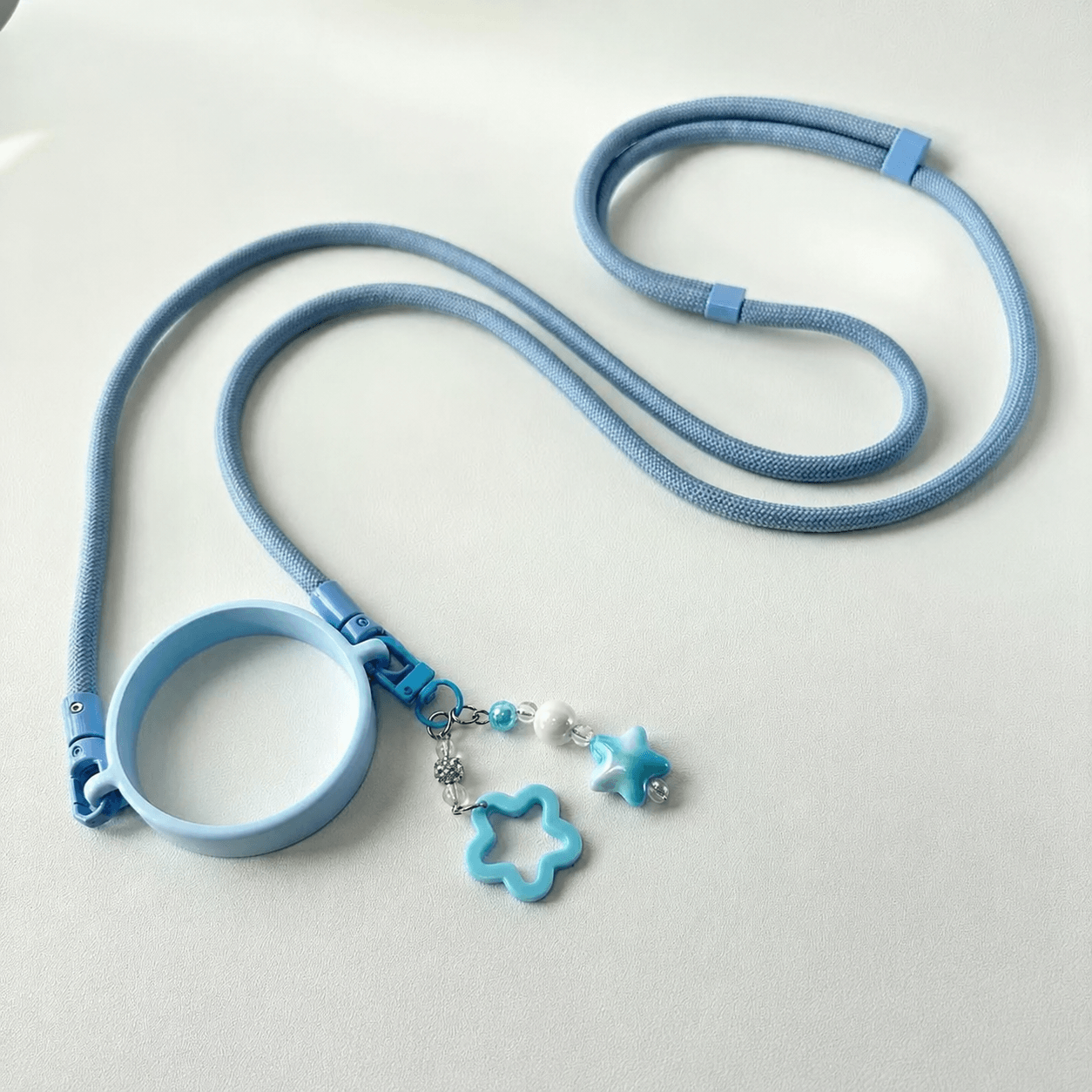 Blue pet leash with a star-shaped charm on a light gray background