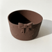 Brown silicone tumbler boot sleeve with an embossed bow pattern and decorative bow accent, designed to fit tumblers with a 7.5 cm base diameter for added protection and style.