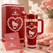 Red Stanley mug with Hello Kitty design, packaging, and stationery set on a light surface.