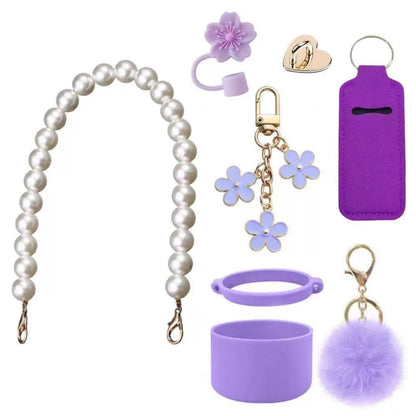 Cute tumbler accessory set including a pearl handle strap, silicone boot, flower straw cap, pom-pom charm, and decorative cup accessories designed to personalize tumblers and water bottles.