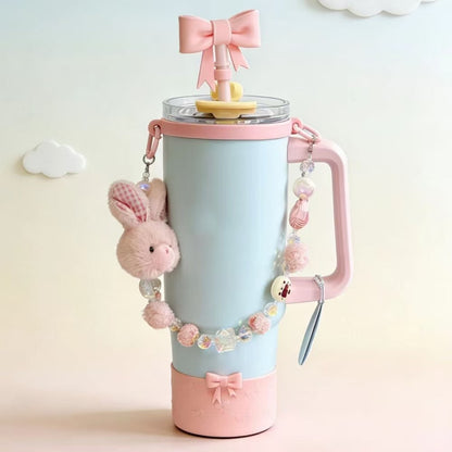 Decorative water bottle with pink accents and a bow on a light background