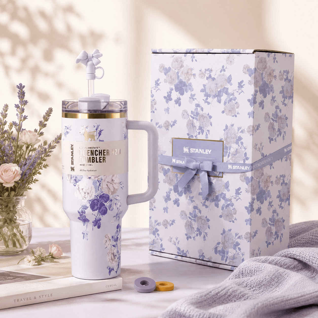 Floral-patterned Stanley tumbler with matching gift box on a soft background