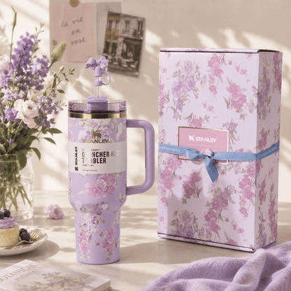 Floral-themed Stanley tumbler with matching gift box on a decorative surface.