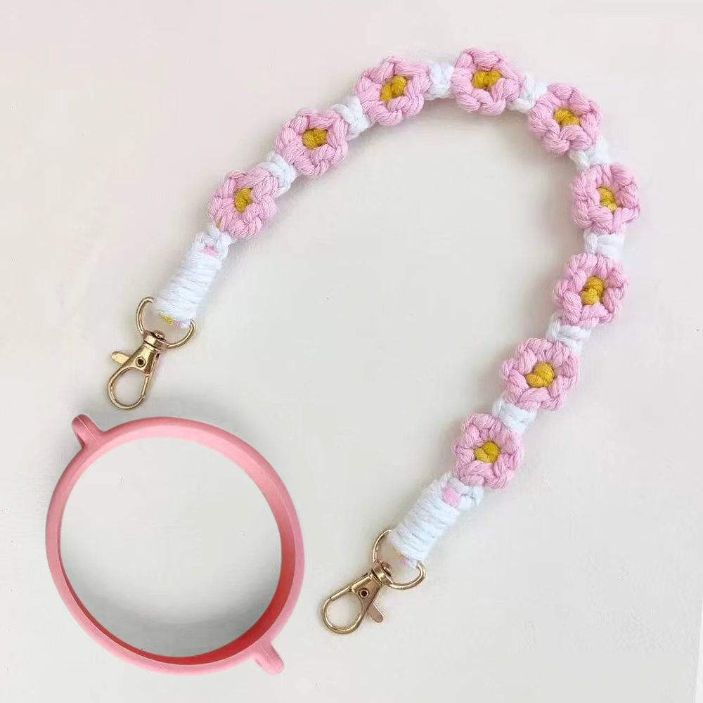 Floral crocheted lanyard with a pink mirror on a light pink background