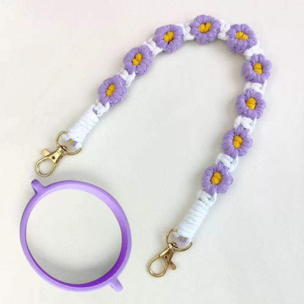 Floral keychain with a purple phone holder on a white background