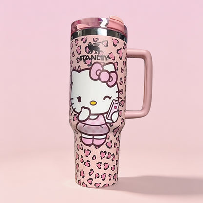 Stanley 40oz insulated tumbler featuring Hello Kitty artwork, pink leopard print pattern and pastel pink ergonomic handle