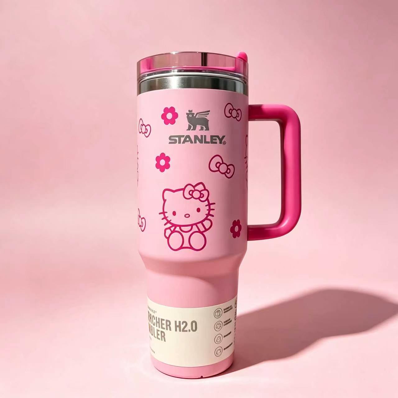 Stanley 40oz insulated tumbler with Hello Kitty illustrations, pink background, red handle, and cute floral accents