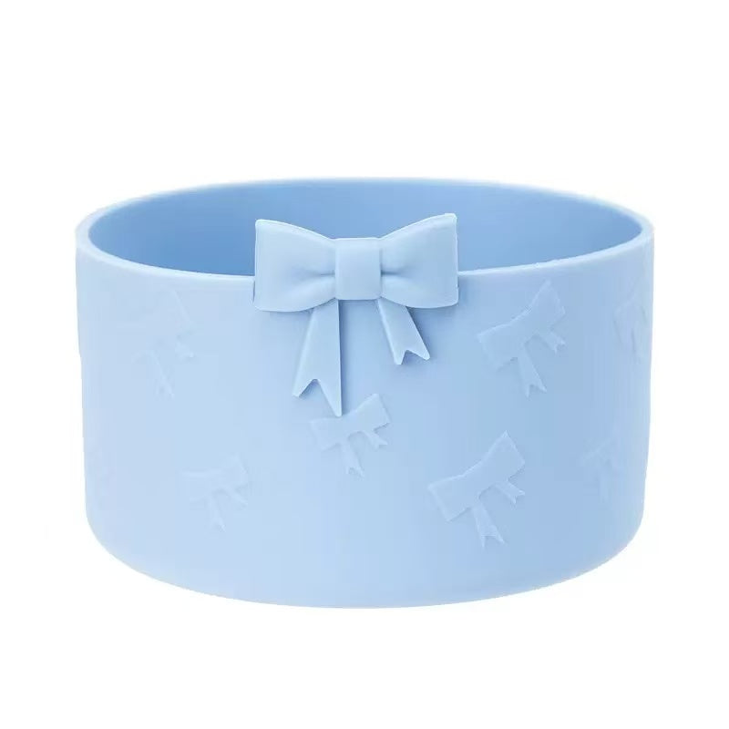 Light blue silicone bowl with a bow design on a white background