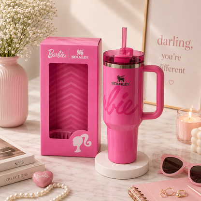 Pink Stanley Barbie mug with packaging on a decorative surface