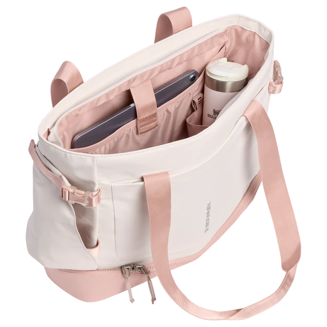 Pink and white backpack with compartments on a white background