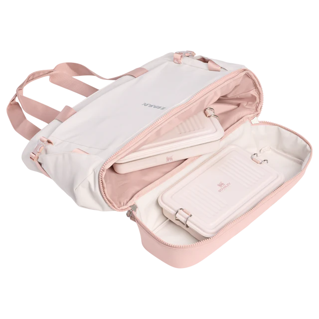 Pink and white jewelry case with a strap on a white background