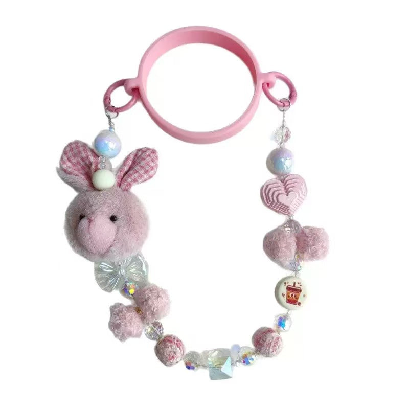 Pink plush bunny keychain with beads on a white background