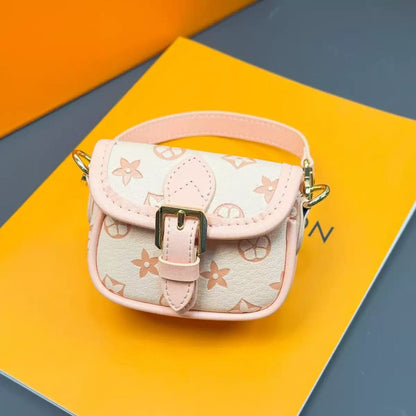 Small pink and beige handbag with floral pattern on a colorful geometric background