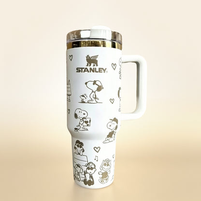 Stanley 40oz insulated tumbler with Snoopy and Woodstock illustrations, hearts and playful icons, white ergonomic handle
