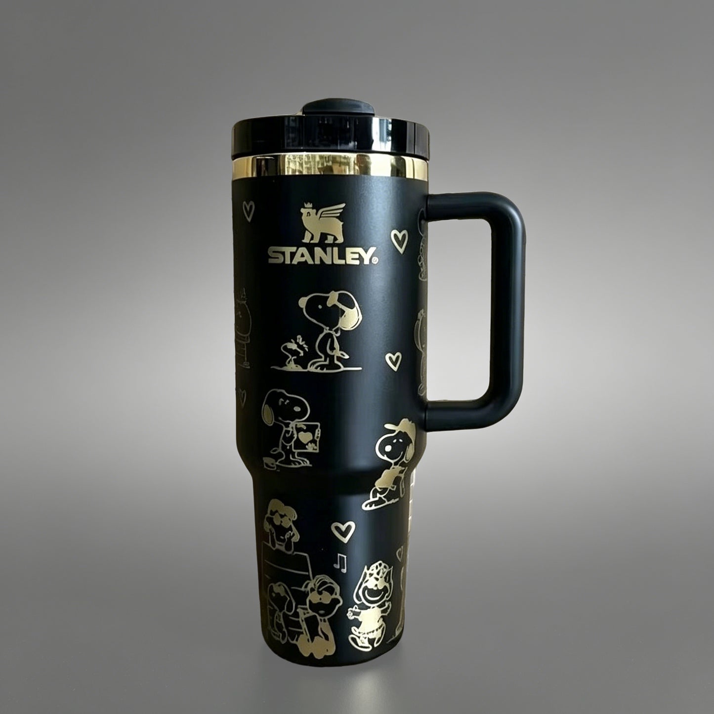 Stanley 40oz insulated tumbler with Snoopy and Woodstock illustrations, hearts and playful icons, white ergonomic handle