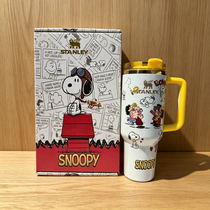 Stanley 40oz insulated tumbler with Snoopy and friends illustrations, comic strip background, yellow handle