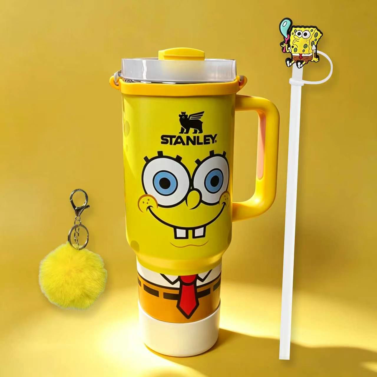 Stanley 40oz insulated tumbler with SpongeBob SquarePants design, yellow body, matching yellow straw and fluffy keychain