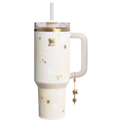 Stanley 40oz insulated tumbler featuring celestial star pattern, gold accents, hanging star charm, and cream ergonomic handle