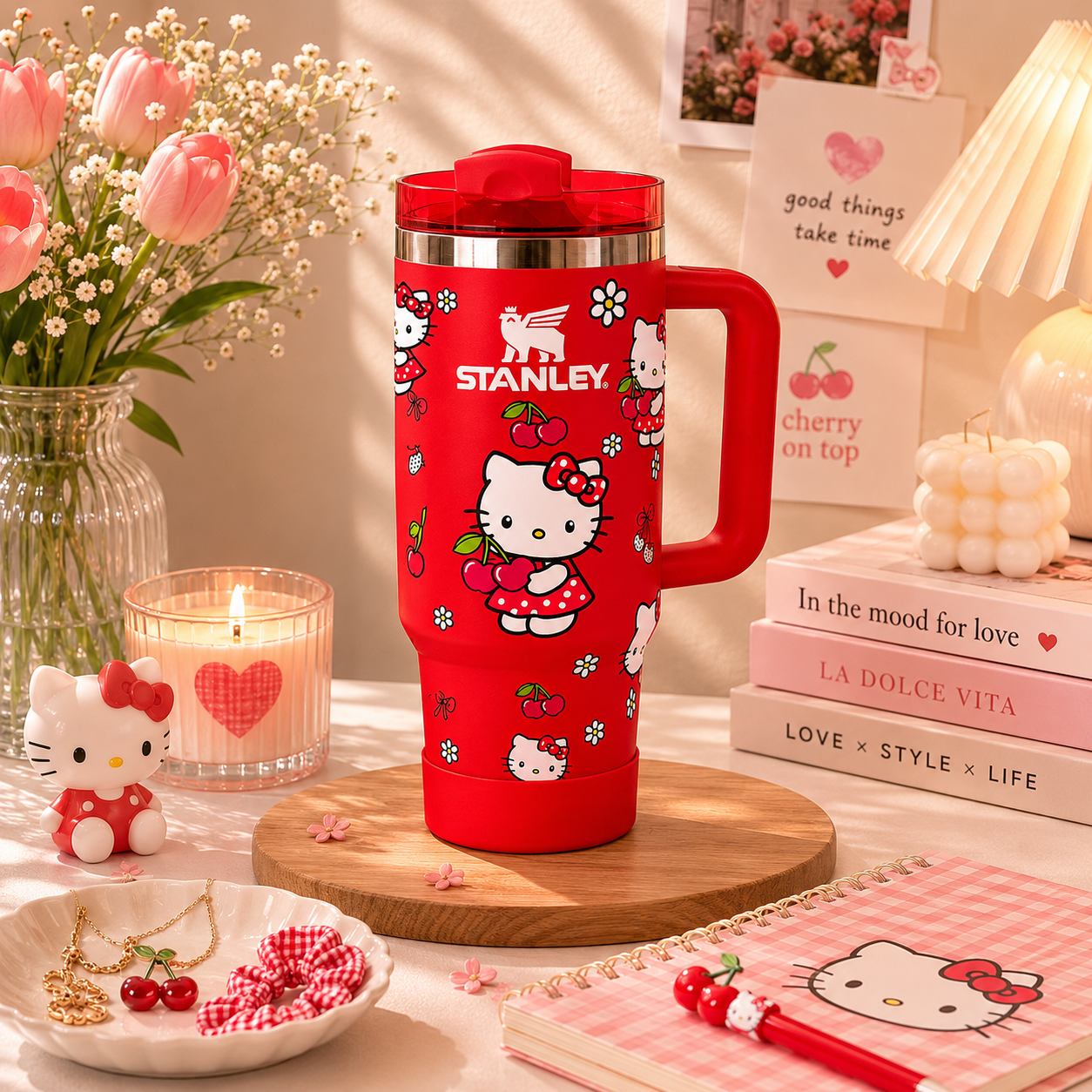 Red Stanley mug with Hello Kitty design on a decorative table