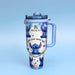 Stanley tumbler with cartoon character design on a light blue background