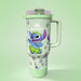 Stanley tumbler with cartoon character design on a light green background