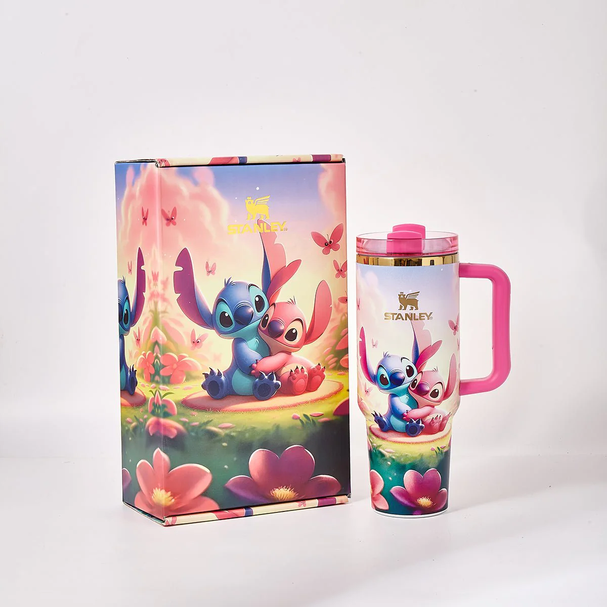 Stanley 40oz insulated tumbler with Stitch character design, vibrant blue and pink accents, matching Stitch-themed gift box, pink handle
