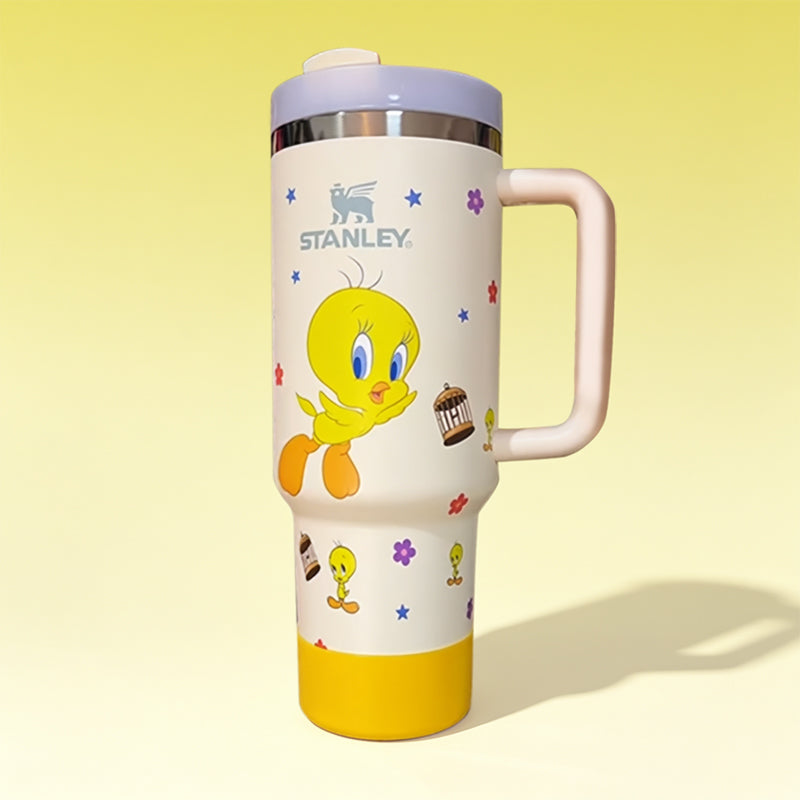 Stanley 40oz insulated tumbler featuring Tweety Bird artwork, colorful flower accents, white body with pastel pink ergonomic handle