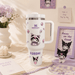White Stanley tumbler with cartoon character design on a decorative surface with flowers and frames.