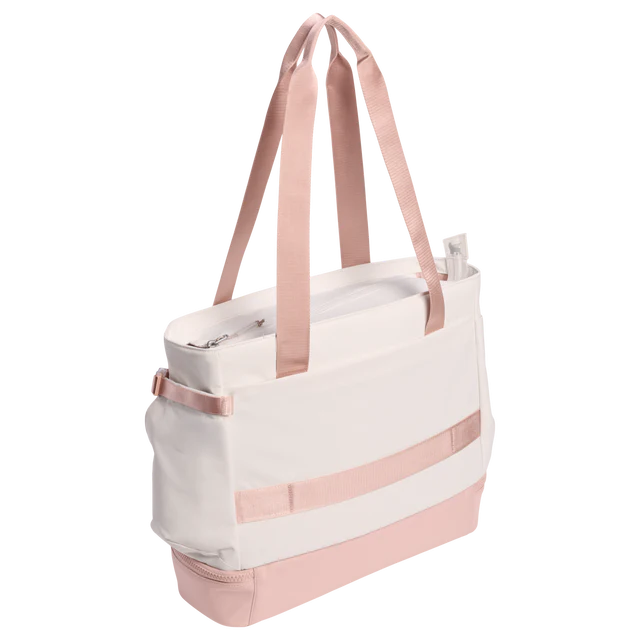 White tote bag with pink straps and accents on a white background