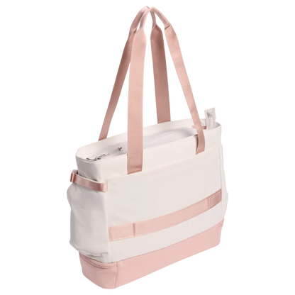 White tote bag with pink straps and accents on a white background