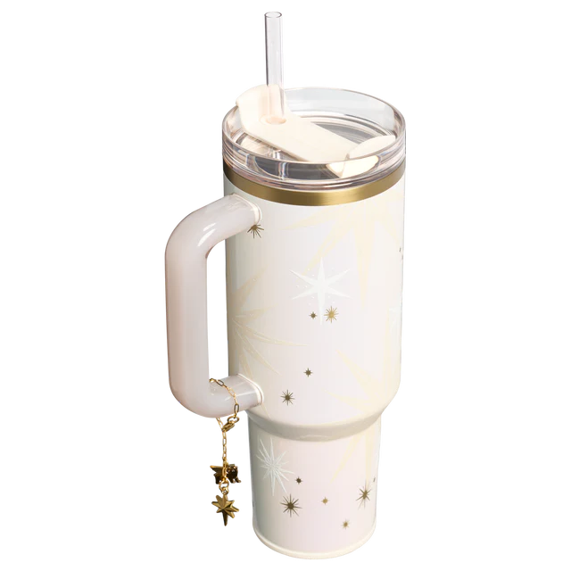 White tumbler with gold accents and star designs on a white background