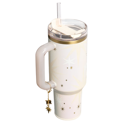 White tumbler with gold accents and star designs on a white background
