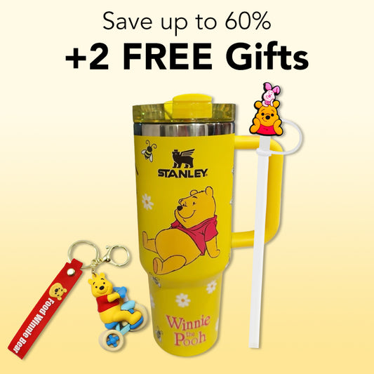 Stanley 40oz insulated tumbler featuring Winnie the Pooh artwork, yellow honey-inspired design, matching straw topper and keychain accessory