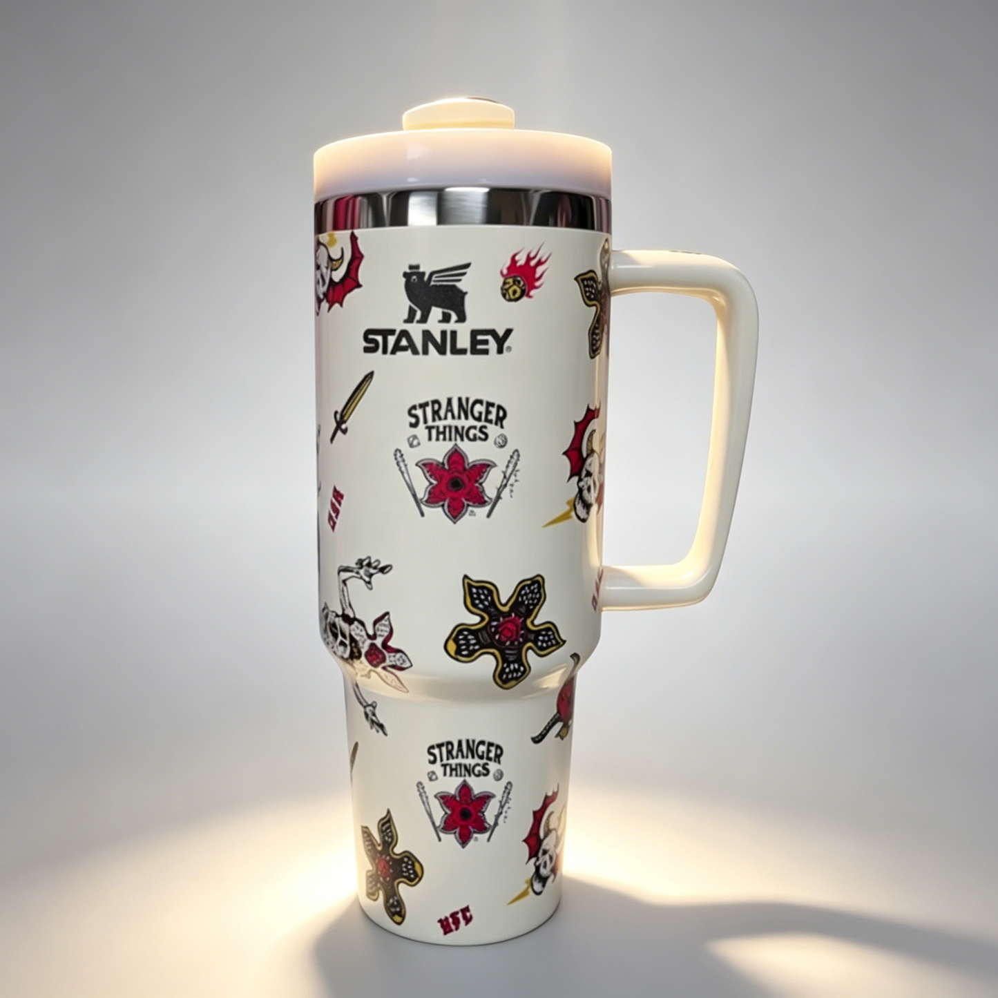 Stanley 40oz insulated tumbler with assorted tattoo-style graphics including skulls, roses, and stars, white handle