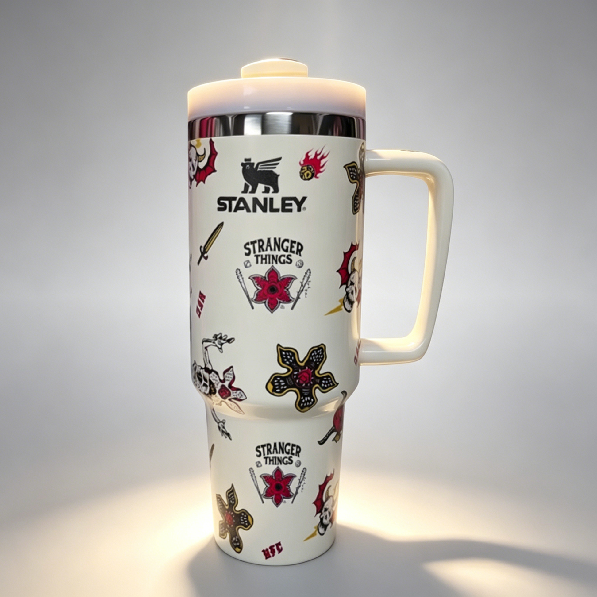 Stanley 40oz insulated tumbler with assorted tattoo-style graphics including skulls, roses, and stars, white handle