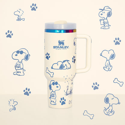 Stanley 40oz insulated tumbler featuring Snoopy illustrations, blue paw prints and bone icons, white body with white ergonomic handle
