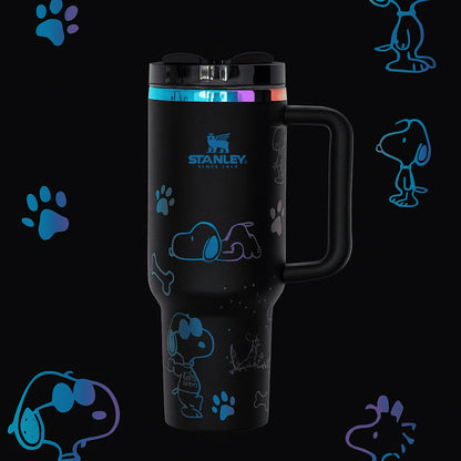 Stanley 40oz insulated tumbler featuring Snoopy illustrations, blue paw prints and bone icons, white body with white ergonomic handle