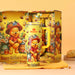 Stanley 40oz insulated tumbler featuring Winnie the Pooh design with honey pot and floral illustrations, yellow background, matching gift box