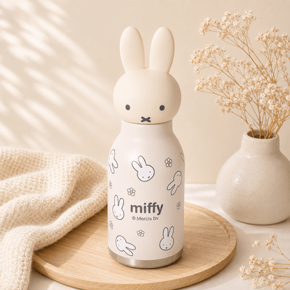 Miffy-themed water bottle on a wooden tray with a neutral background