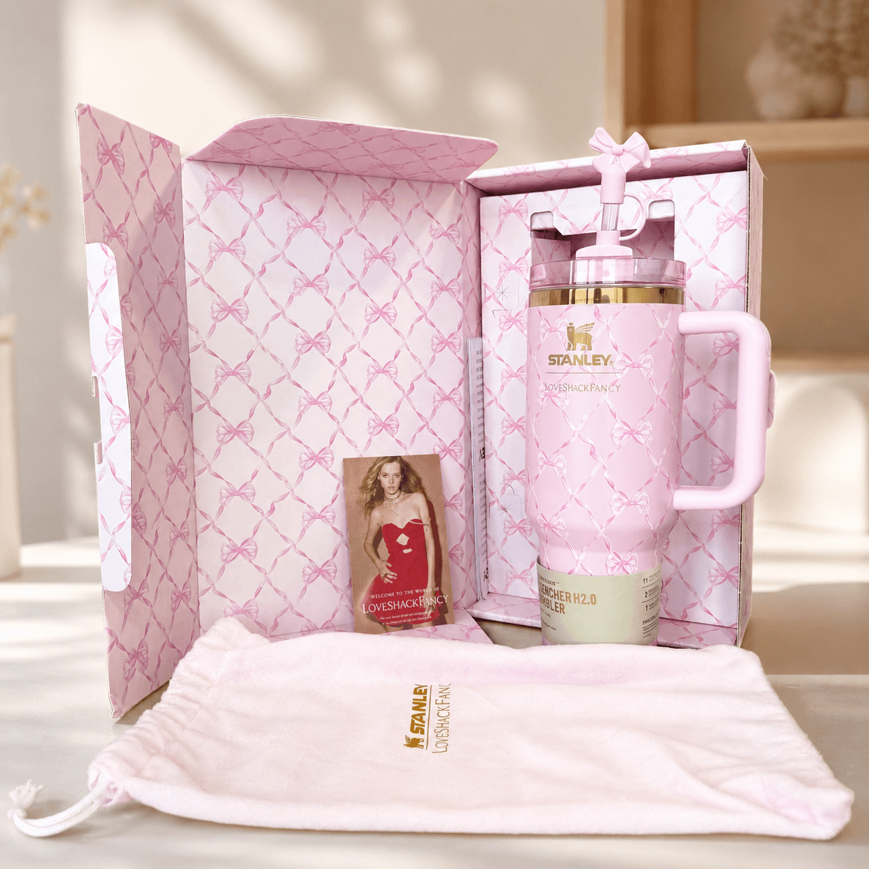 Pink Stanley mug with decorative packaging on a light background